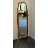 A Georgian-style walnut cheval mirror, on end supports with castors.