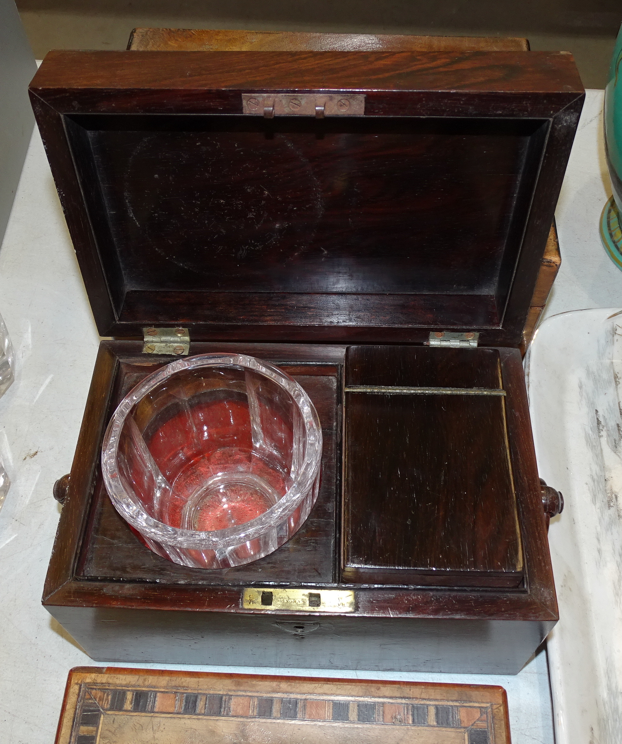A 19th century rosewood tea caddy with interior cannister and glass mixing bowl, fitted with ring