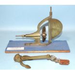 A brass model of a Stern Frame clockwork rudder and propeller c1940, 21cm long, on stand and a brass