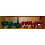 A green glass decanter with clear glass stopper and handle, six matching tumblers and nine various