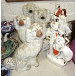 Two pairs of Staffordshire spaniels, 32cm and 31cm high, a pair of Staffordshire flatback figures on