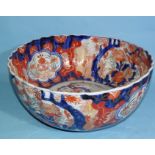 A large Japanese Imari porcelain fluted punch bowl decorated with vases of flowers, 33cm diameter.