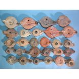 A collection of twenty-seven Greek, Roman and early pottery oil lamps.