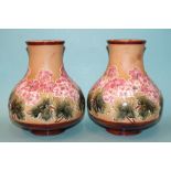 A pair of Doulton & Slaters stoneware squat baluster-shaped vases by Florence C Roberts, with pink