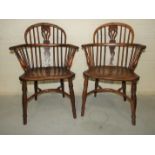 A pair of 19th century yew wood comb-back Windsor chairs, with shaped elm seats and crinoline