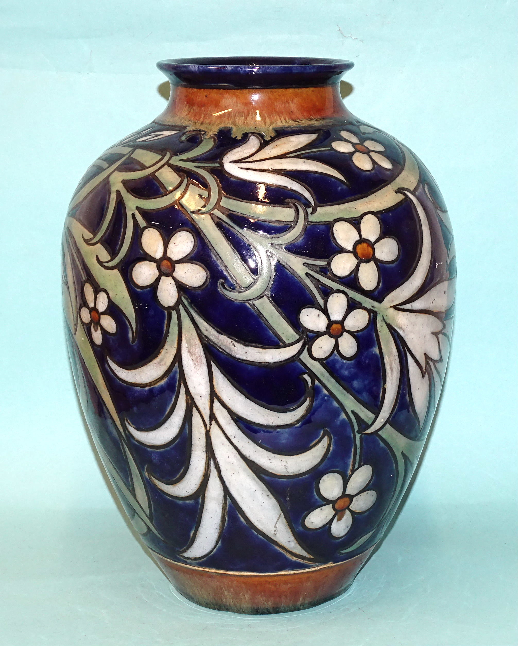 A Royal Doulton stoneware baluster-shaped vase by Harry Simeon, with stylised floral and leaf