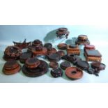 A collection of approximately 30 Oriental wood stands for vases and works of art, (various sizes,