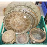 A collection of Middle Eastern embossed trays, cooking wares and other vessels.