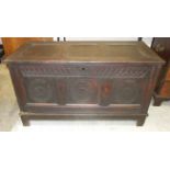 A carved oak coffer, the panelled front carved with three roundels, 120cm wide, 68cm high.