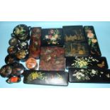 A collection of approximately 25 pieces of early-20th century lacquered wood and papier-mâché boxes,