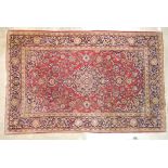 An early to mid-20th century Persian rug, the symmetric design with pole medallion on crimson and