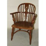 A 19th century yew wood comb-back Windsor chair with shaped elm seat.