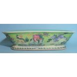 A Chinese famille rose rectangular footed bowl decorated with mythical beasts in a rocky