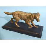 A gilt metal figure of a sporting dog, on black marble base, 20cm long, 8cm high, the base 25 x 9cm.