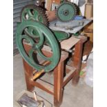 An early-20th century etching and print press and accessories on oak stand, press 74cm long, 46cm