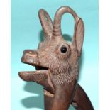 A Black Forest carved wood pair of nutcrackers in the form of a chamois, with glass eyes, 19cm.