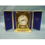 A Jaeger LeCoultre Atmos clock, the plain white enamel dial in plain gilt metal case with