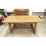 An early-20th century Arts & Crafts oak dining table, the plank top above a single frieze drawer, on