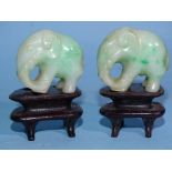 Two carved jade elephants on stands, 4.8cm overall, (3).