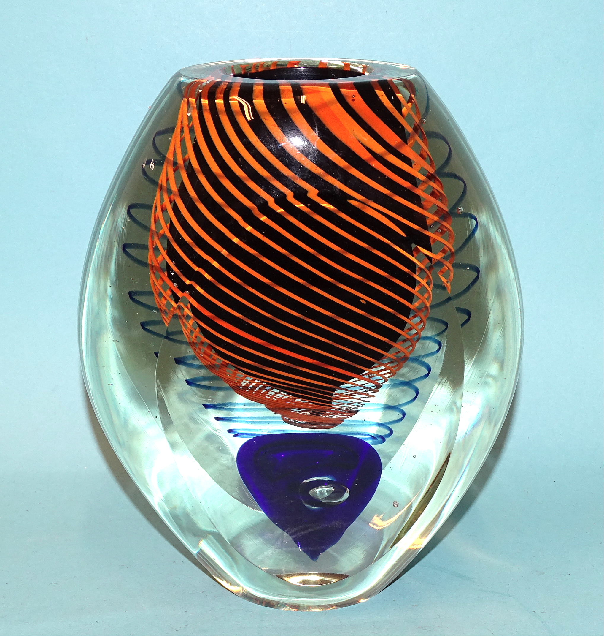 A Murano-style glass vase, the internal decoration of orange and blue strands around a black core,