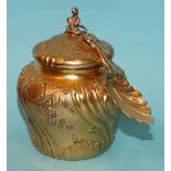 A French silver-gilt tea caddy of baluster form, with embossed scroll and floral decoration, 10.5cm,