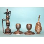 A Middle Eastern white metal nargile/hookah, 19.5cm high, a pair of short candlesticks and a table