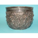 A Burmese silver bowl deeply embossed with deities within scrolling arches, 12.5cm diameter, 9.5cm
