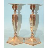 A pair of sterling silver candlesticks of hexagonal tapered form, on hexagonal foot, with engraved