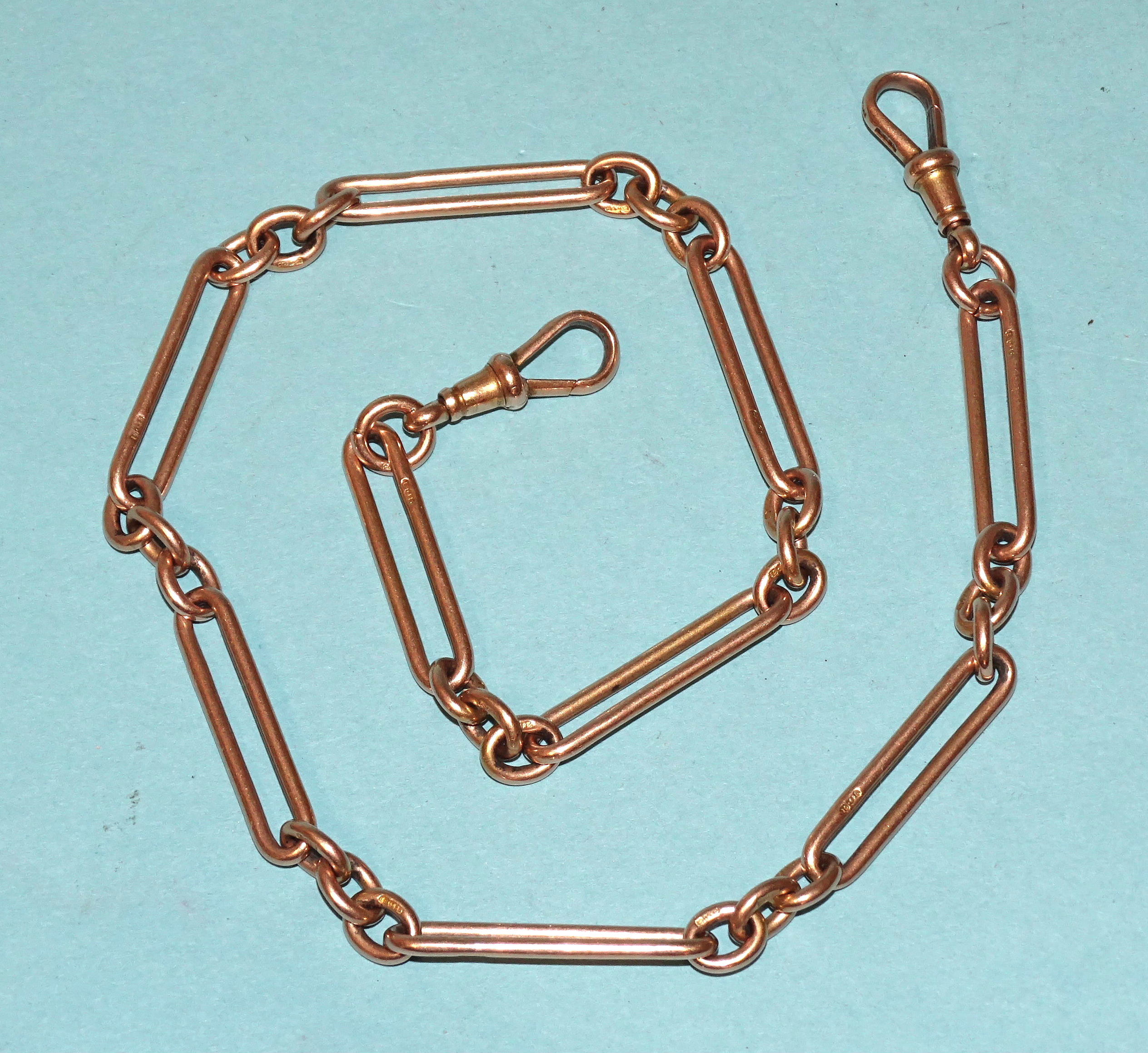 A 15ct rose gold watch chain of long and oval links, 42cm long, (no T-bar), 43.2g.