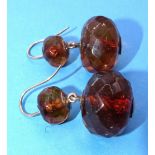 A pair of Victorian amber drop earrings, each set two faceted amber beads, on gold fittings, 35mm