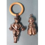 A silver baby's rattle in the form of a teddy bear with bells at his elbows and bone teething