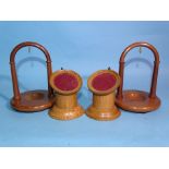 Two modern yew wood arched watch stands, 13.5cm high and two oak pillar watch stands, (4).