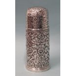 A silver sugar caster of slightly tapered cylindrical form, embossed with scrolls and foliate