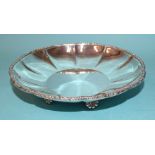 A modern silver dish of lobed form with cast foliate rim, on five shell feet, 16cm diameter,