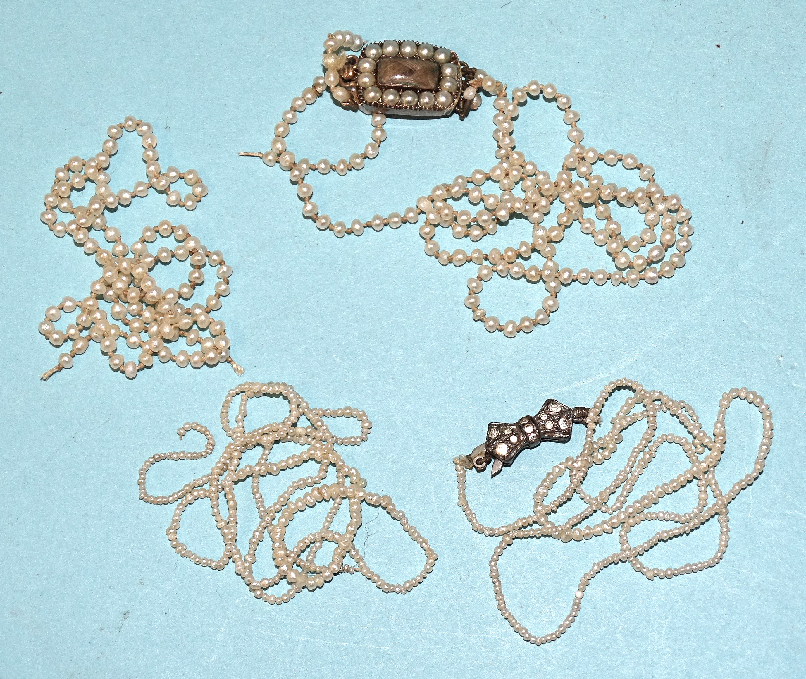 A Georgian seed pearl necklace, the gold hair locket clasp with pearl surround, (originally with