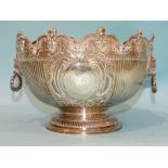 A silver two-handled punch bowl with four ribbed panels and two cartouches within scrolling