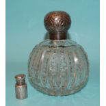 A silver-topped cut-glass scent bottle with stopper, Birmingham 1900 and a white metal miniature