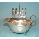 A silver sauce boat with wavy rim and scroll handle, Wm Suckling Ltd, Birmingham 1939 and a silver
