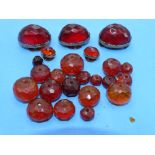 Three large faceted amber lapel studs, two small ones, similar and a quantity of faceted amber