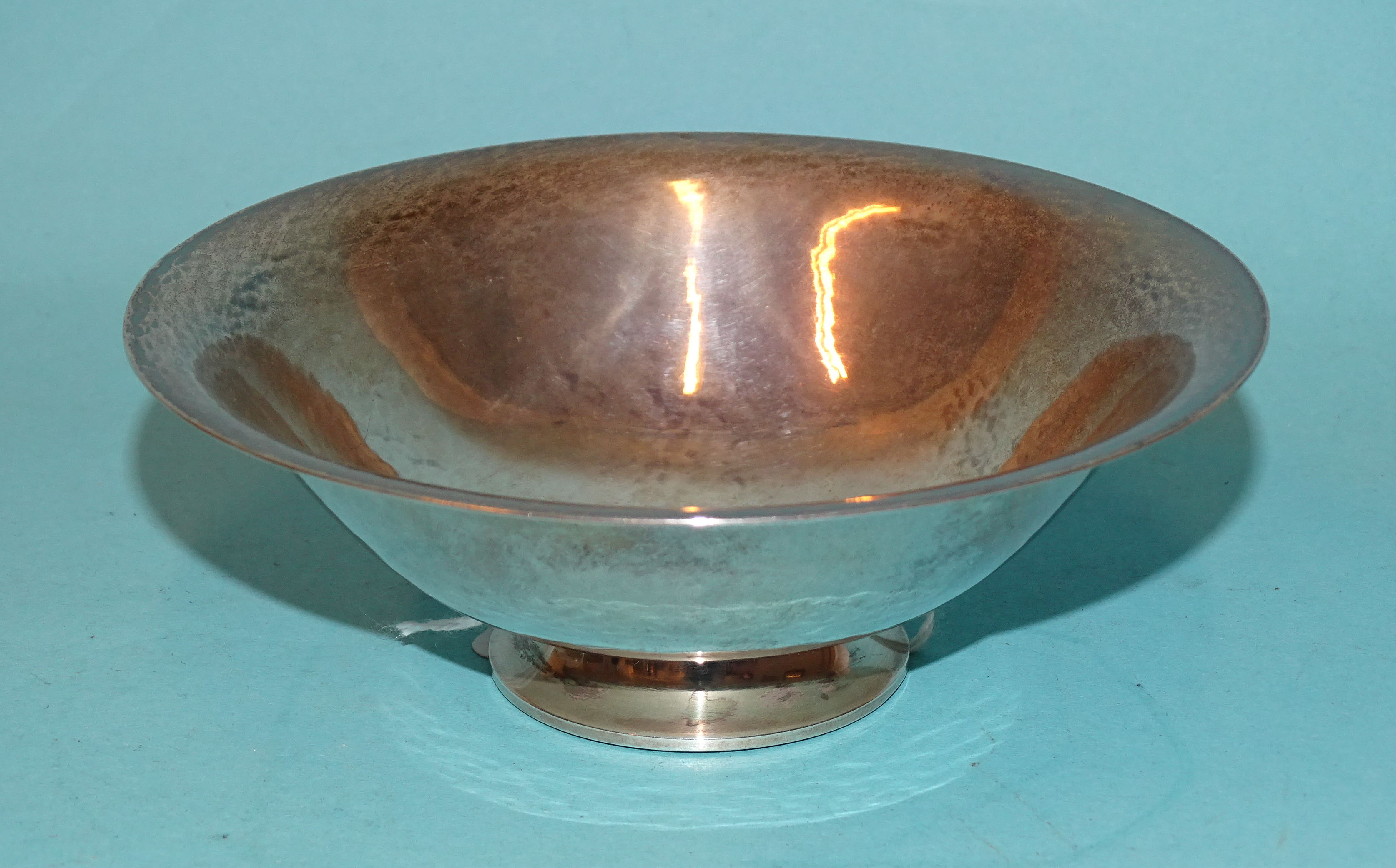 Georg Jensen & Wendel, a small beaten silver bowl on circular foot, marked 925S Denmark, Georg