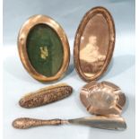Two oval silver photograph frames, Birmingham 1906 and 1907, a silver-handled shoe horn, a silver-
