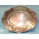 An Egyptian silver oval bowl with embossed and pierced decoration of fruit and leaves, on four feet,