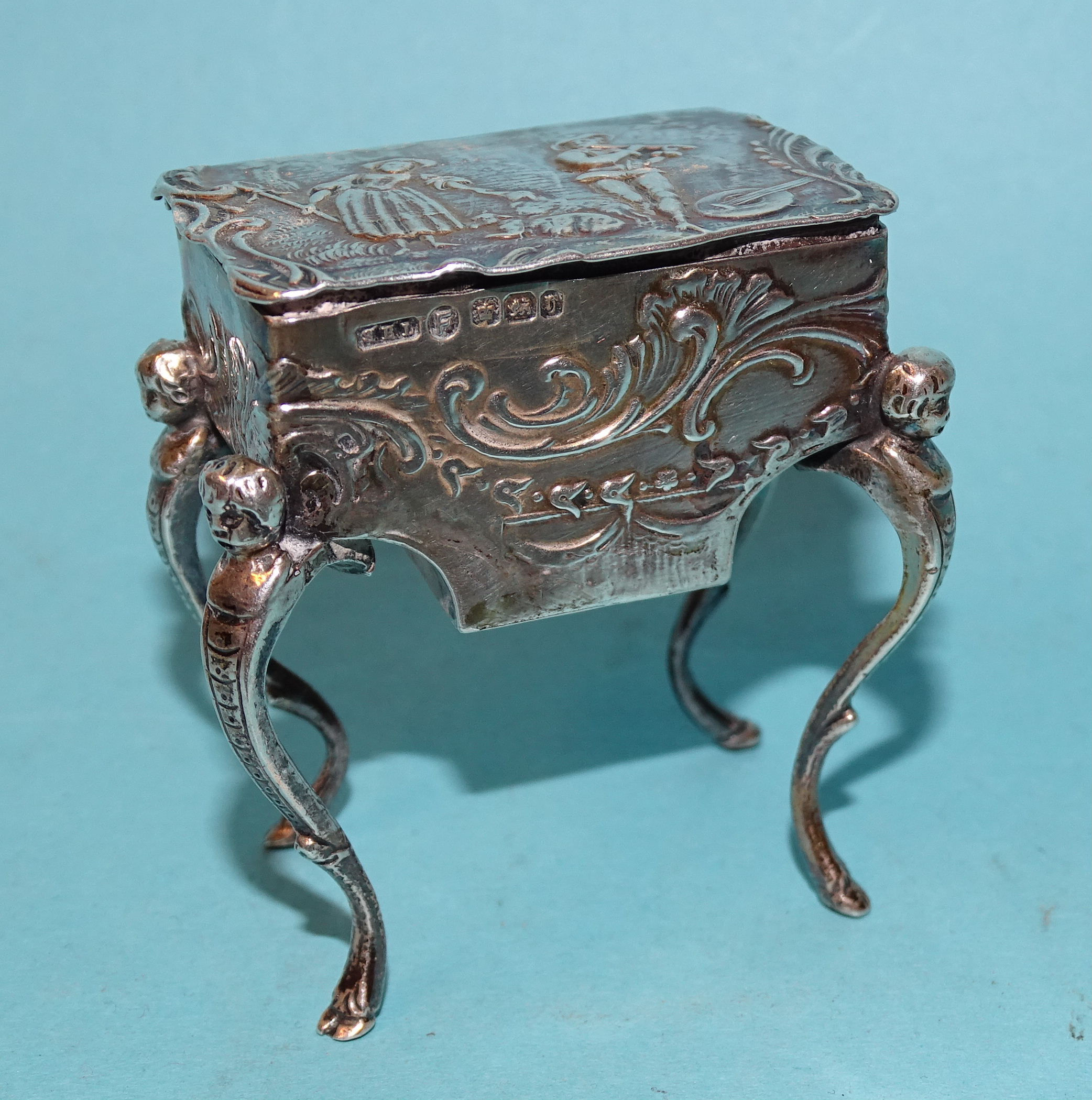 A Continental silver pill box in the form of a worktable, on cabriole legs, with embossed - Image 3 of 11