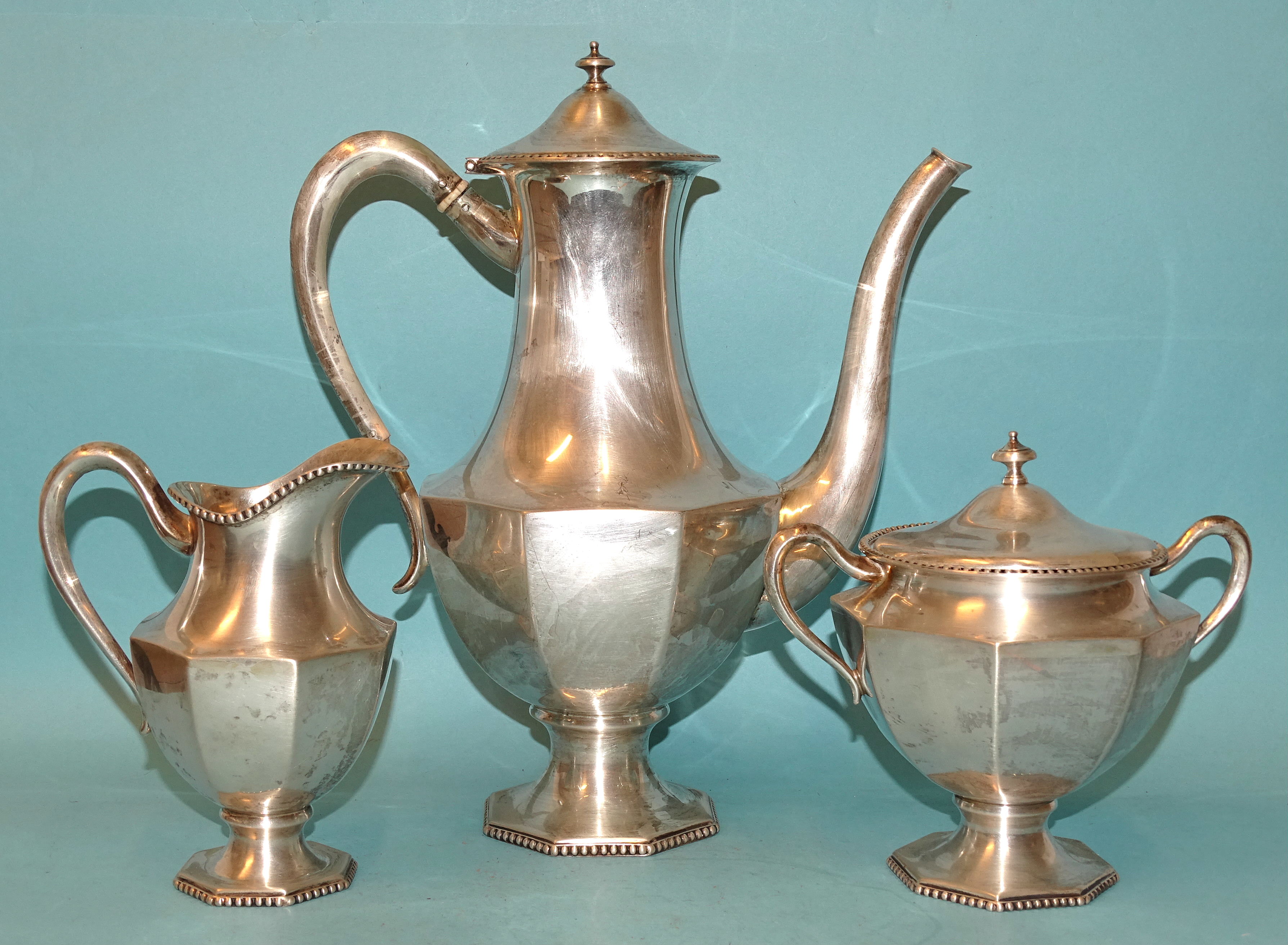 An 800-silver three-piece coffee service of octagonal baluster form, each with beaded rim and