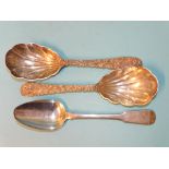 A pair of Oriental serving spoons with prunus-decorated handles and shell bowls, marked 'LW' and a