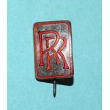 A Rolls Royce hallmarked silver lapel badge with red enamel RR logo, by J R Gaunt & Son, numbered