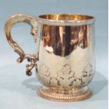 A silver tankard with applied leaf frieze and scroll handle, raised on gadrooned foot, Asprey &