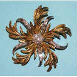A spectacular yellow and white gold floral brooch of engraved yellow gold and brilliant-cut