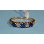 A sapphire and diamond ring claw-set three round-cut sapphires and two brilliant-cut diamonds, in