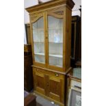 A pitch pine dresser, the cornice above a pair of glazed doors, the base with single drawer and a